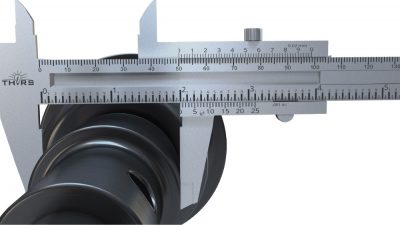 A vernier caliper measuring a part.