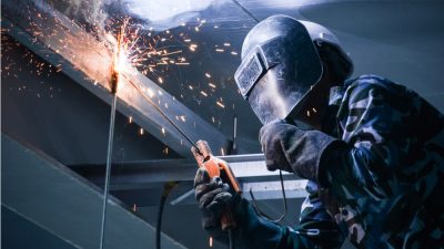 A person welding, a commonly used metal fabrication process for a variety of fields and industries.