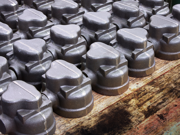 Cast iron parts after solidification in a green sand foundry.