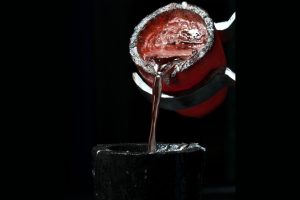 A sample of molten aluminum being poured into a crucible
