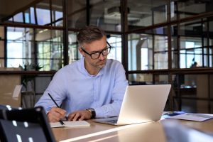 Man on laptop doing eLearning support work