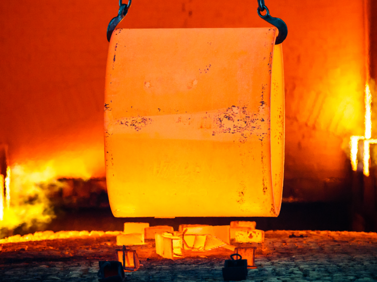 A metallic product undergoing heat treatment in a manufacturing process in an industrial setting.