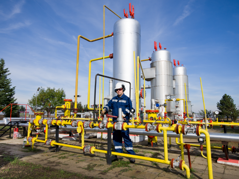 A plant operator adjusting the valve in natural gas production plant