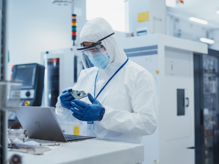 A technician wears ESD protective clothing while working on sensitive equipment.