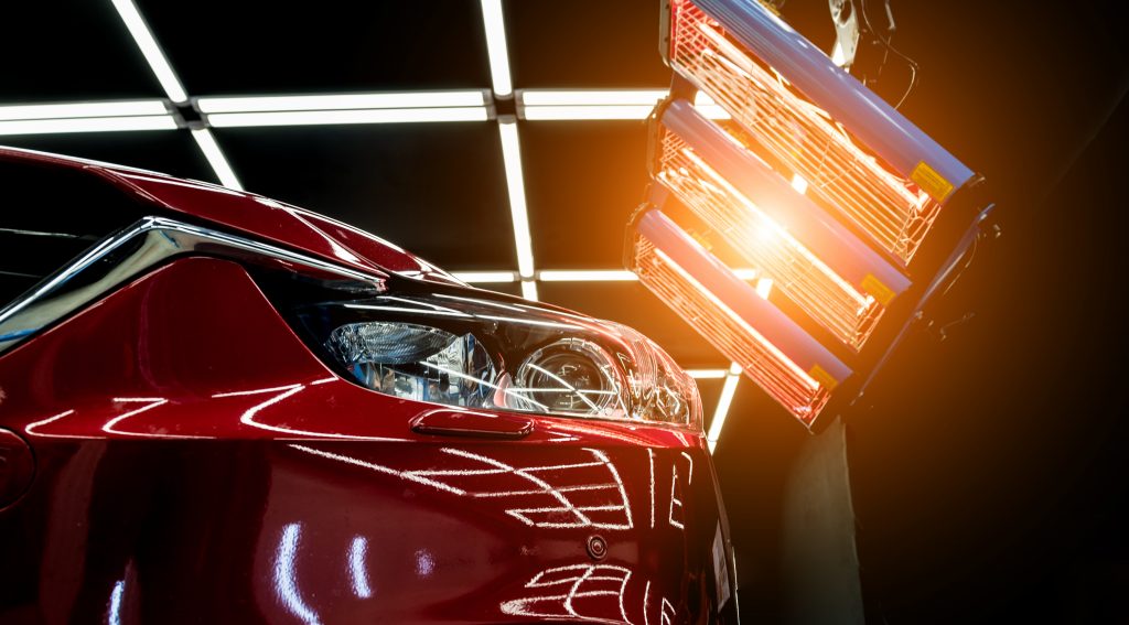 CED paint on a car drying under infrared lamps