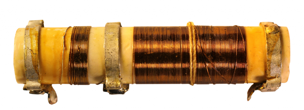 A picture of a wirewound resistor with wires wound around a ceramic core, showing how far the evolution of resistor technology has come.