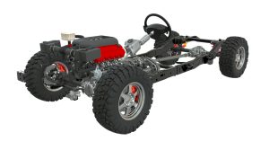 3D model of a chassis system showing the engine, steering wheel, suspension, wheels, and frame components without the vehicle body.
