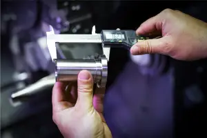 An inspector measuring a component as part of Measurement System Analysis (MSA) best practices.