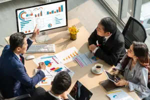Professionals discussing statistics and analyzing financial charts.
