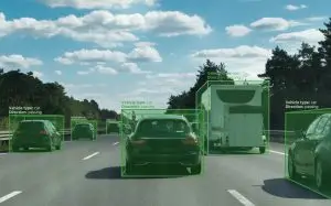 Highway scene with multiple vehicles detected by ADAS technology, highlighted with bounding boxes for object recognition.