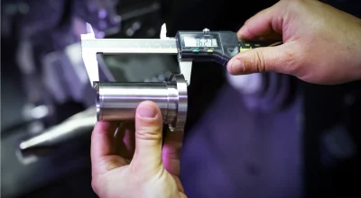 An inspector measuring a component as part of Measurement System Analysis (MSA) best practices.